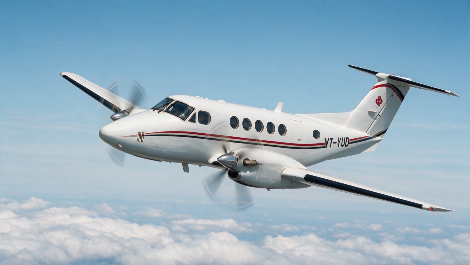 Airlogic King Air B200, registration VT-YUD, in flight above cloud